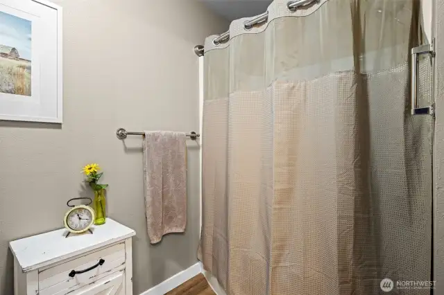 The primary bathroom includes a full tub and shower combo—perfect for a relaxing soak or a quick rinse, whatever the day calls for.