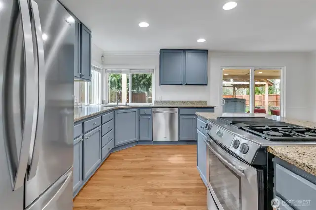 This kitchen layout creates the perfect ergonomic triangle functionality between refrigerator, stove, and under-mount sink.
