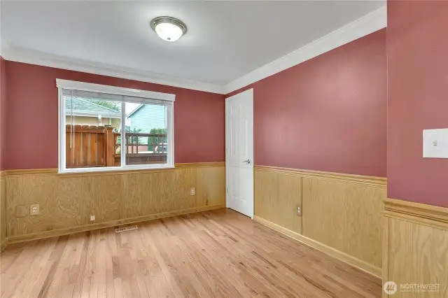 The main level bedroom could also serve as a perfect office space complete with attractive wood chair rail and wainscoting.
