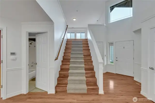 A beautiful, wide staircase leads to the upper level great room.