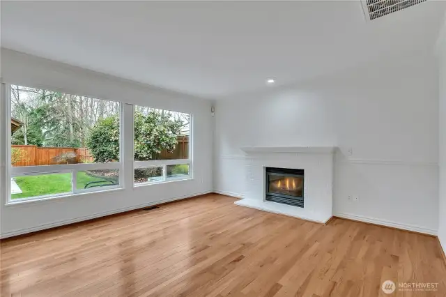 The family room is adorned with large picture windows overlooking the backyard and is complete with a cozy gas fireplace for maximum comfort on cold nights.