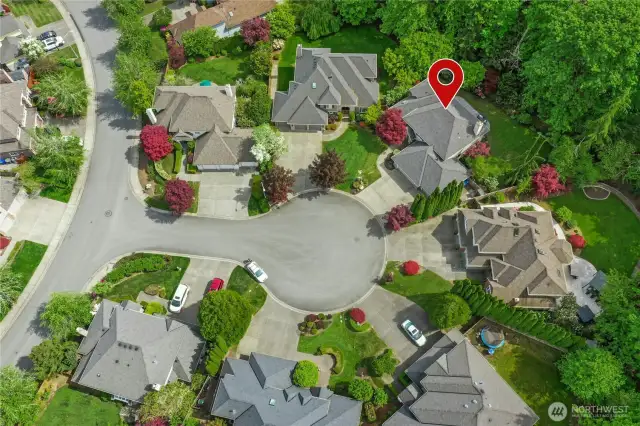 Nestled in a picturesque cul-de-sac, this home stands out with its lush landscaping and meticulous curb appeal. Surrounded by mature trees and vibrant seasonal foliage, the property boasts privacy and tranquility while being perfectly positioned for community living.
