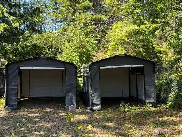 Two storage tents/car ports with steel roofs.
