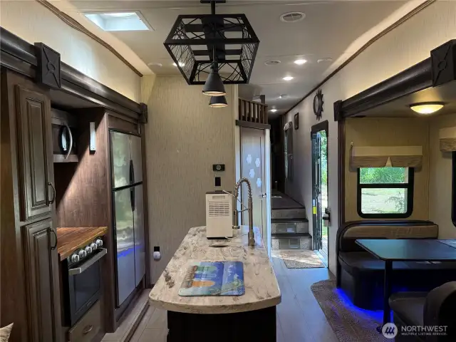 Large capacity refrigerator. Note the lighting fixture above the island,