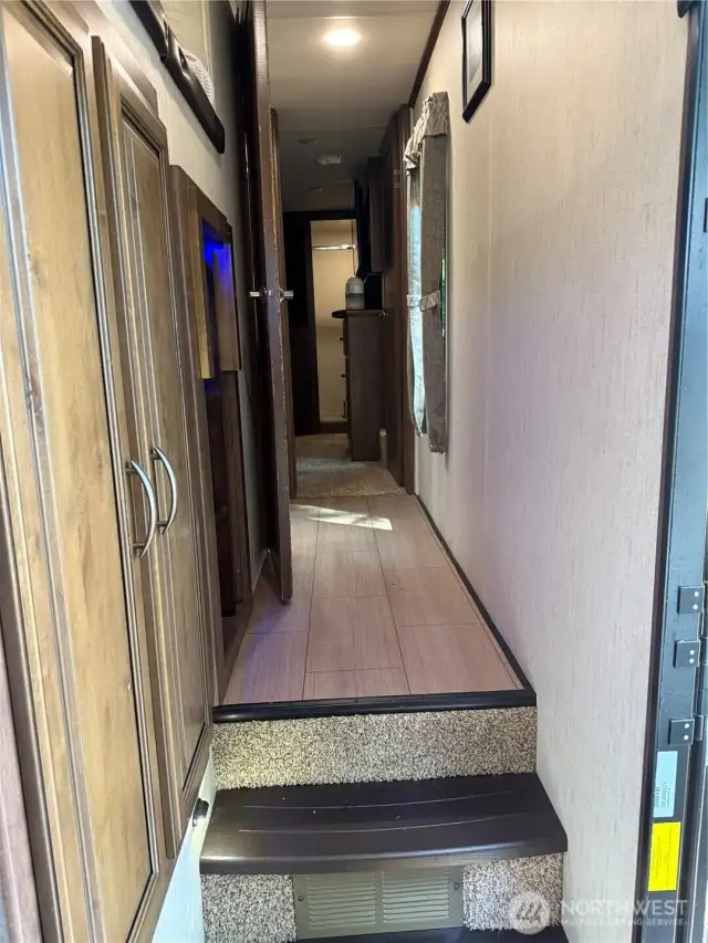 Storage in hallway leading to the bath and primary bedroom.