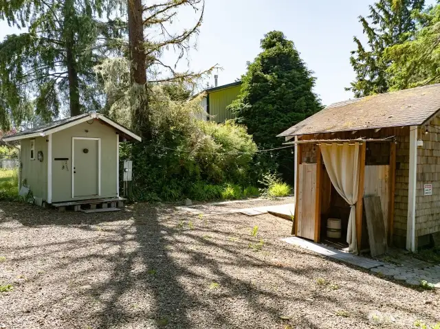 Laundry shed and a lean-to for a outdoor shower is so choice.