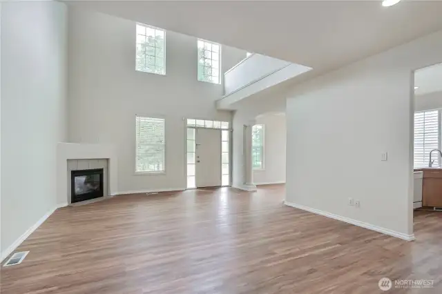 Spacious family room with cozy gas fireplace.  Nearly new vinyl plank flooring.