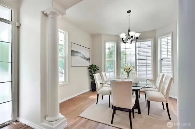 Dining area with architectural details and bay windows.