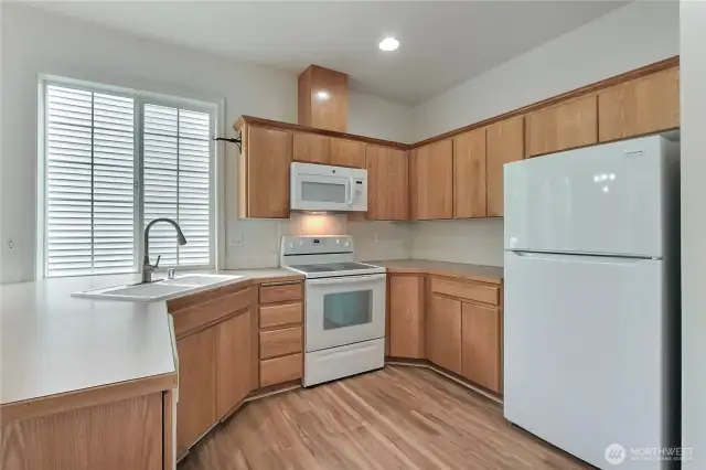 Kitchen is open to the dining area.  Newer fridge.