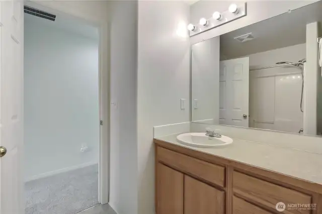 Hall bath features a tub/shower surround.