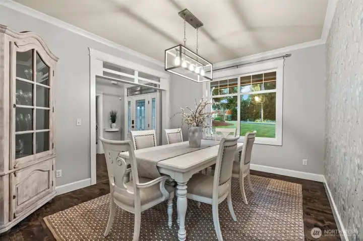 Charming formal dining room with custom wallpaper detail.