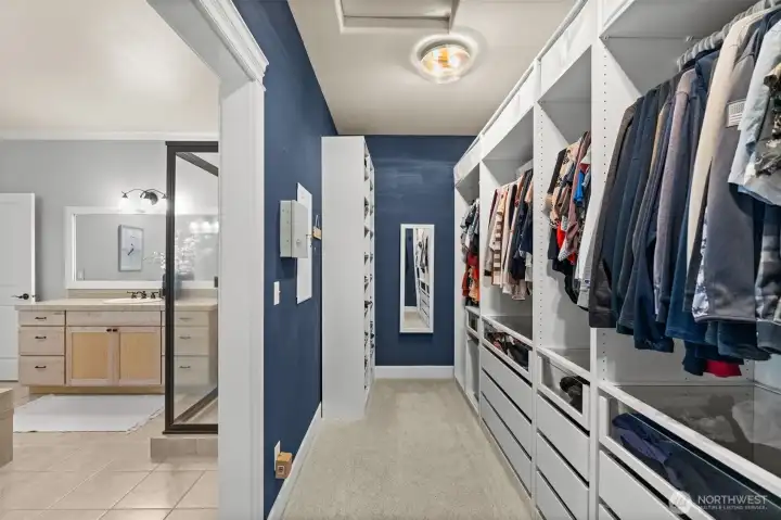 Massive walk-in closet with custom-built cabinetry.