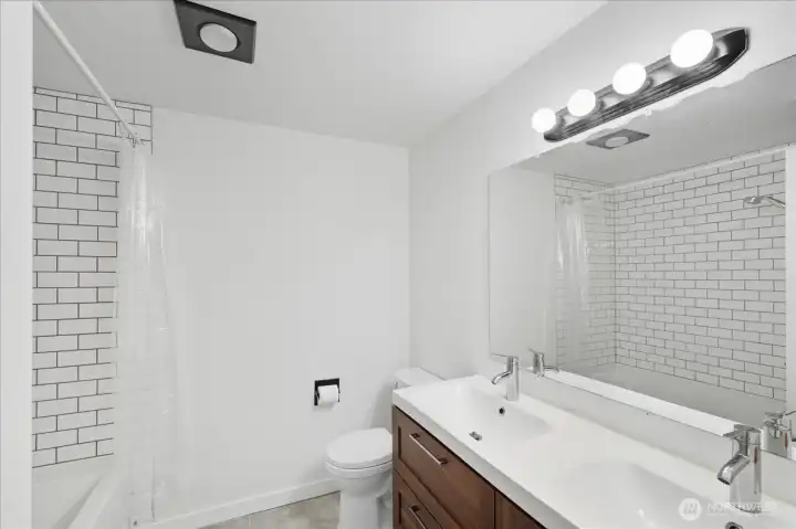 Main Bath with tile tub/shower surround.