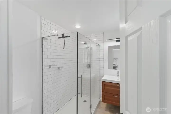 Primary bath with glass wall/tiled shower.