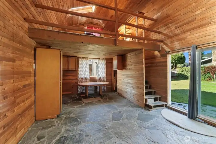 Great room has an upstairs loft and main floor cabinets.