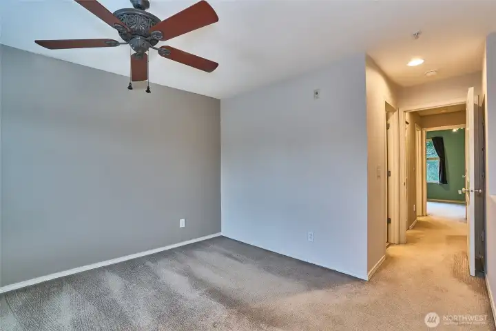 Primary bedroom with ceiling fan.