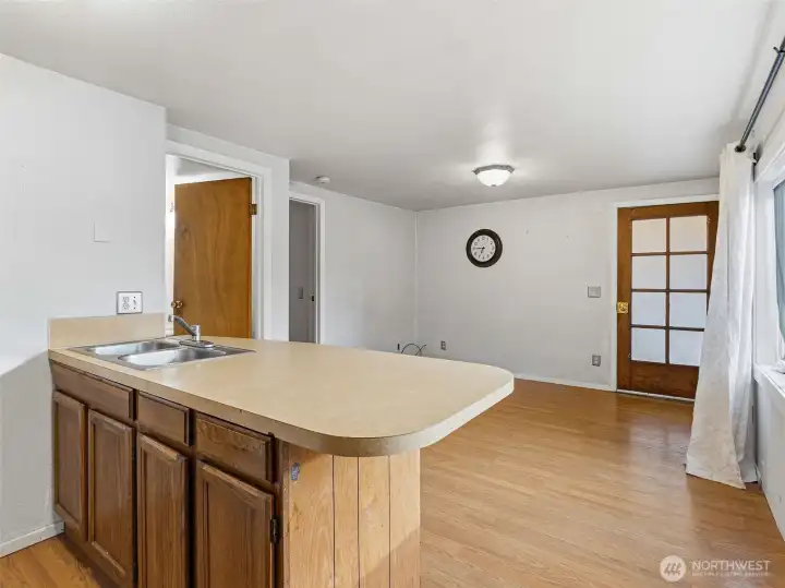 Kitchen, lliving area combo with a bar space for eating.