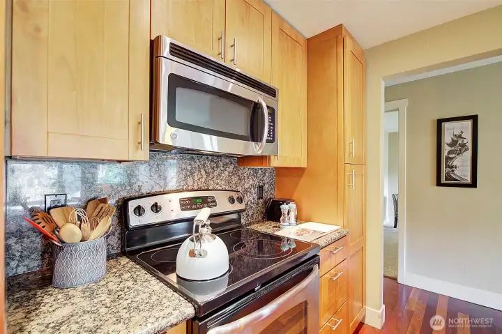 The kitchen features stainless steel appliances and lots of cabinet space.