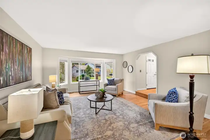 From this angle, the living room shows its spacious proportions and easy connection to the rest of the main level. The bay window expands the room visually and brings in a soft, natural brightness buyers are always looking for.