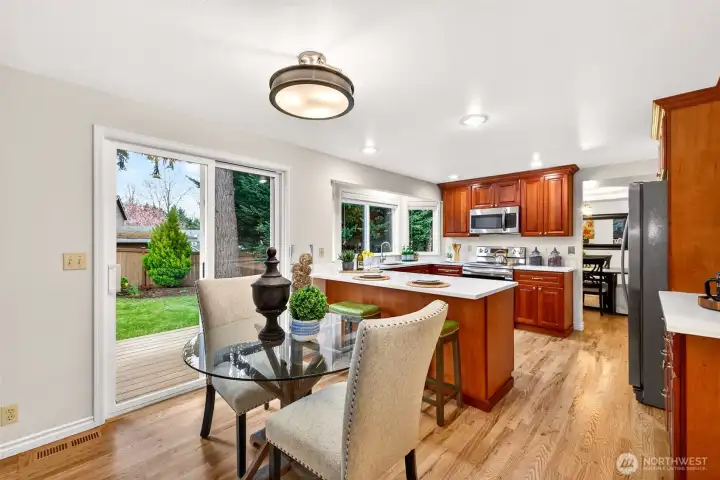 This area shows how naturally the kitchen and informal dining space connect to the outdoors through the slider. The transition to the cedar landing and backyard patio makes indoor outdoor living easy and convenient
