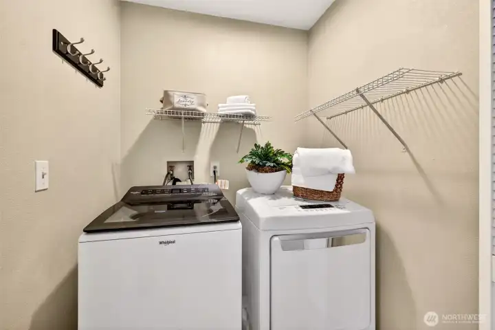 The dedicated laundry room offers practical utility space with room for side by side appliances and additional household organization. Buyers will appreciate having a separate work area tucked conveniently within the home.