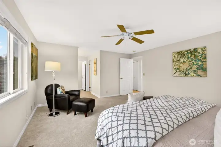 A second angle of the primary suite shows its open feel and easy circulation, reinforcing how comfortably the room can accommodate a wide range of furniture layouts. It is a spacious, restful setting designed for long term livability.