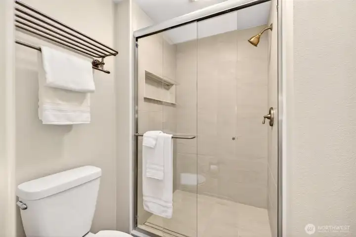 The newly remodeled glass enclosed shower adds a fresh, updated finish to the primary bath. Clean lines and a bright presentation help make this private bath feel both comfortable and functional.