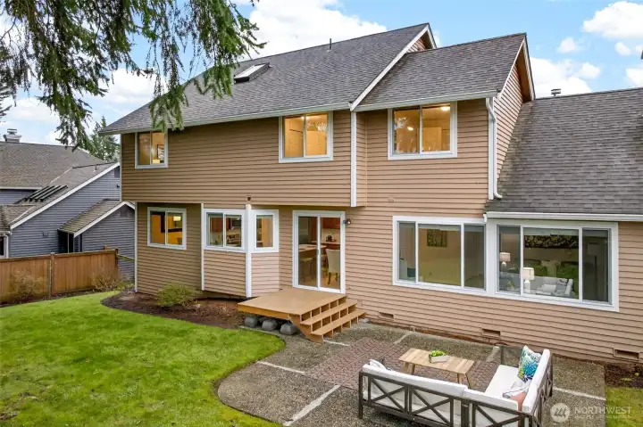 The rear elevation highlights the home’s strong connection to the backyard, with large windows and direct access from the main level. The relationship between indoor spaces and outdoor living is one of the home’s strongest lifestyle benefits.