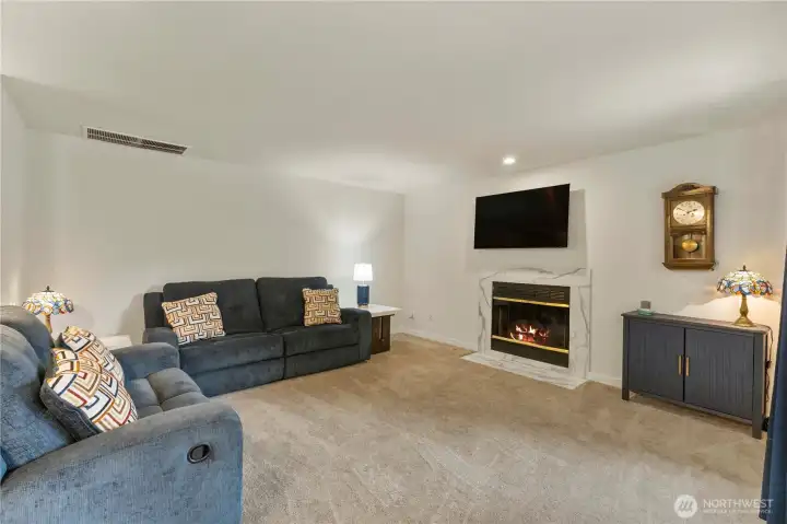 Cozy family room adjacent to the kitchen with gas fireplace.