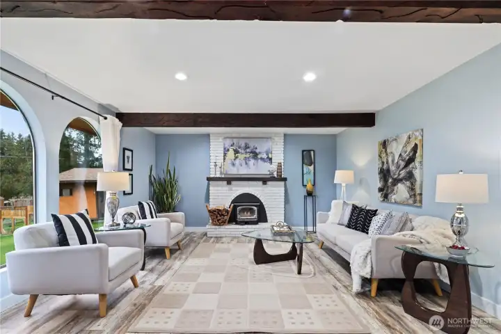 Beautifully updated, light-filled living room with cozy fireplace insert