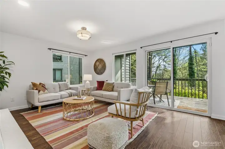 Bright, spacious living room with back patio access and views of the greenbelt