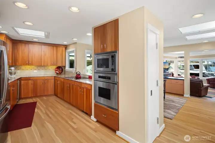Built-in oven and microwave, glass cooktop, and skylights flooding the extensive counterspace: the kitchen is laid out for someone who genuinely uses it.