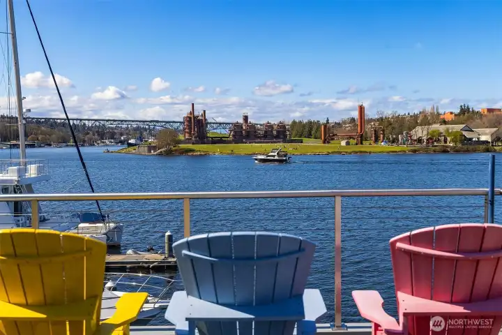 A quieter rooftop moment — comfortable chairs, a passing cruiser, and the iron silhouette of Gas Works Park.