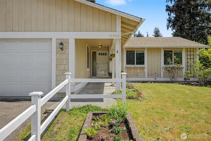 Welcoming white picket fence and covered entry