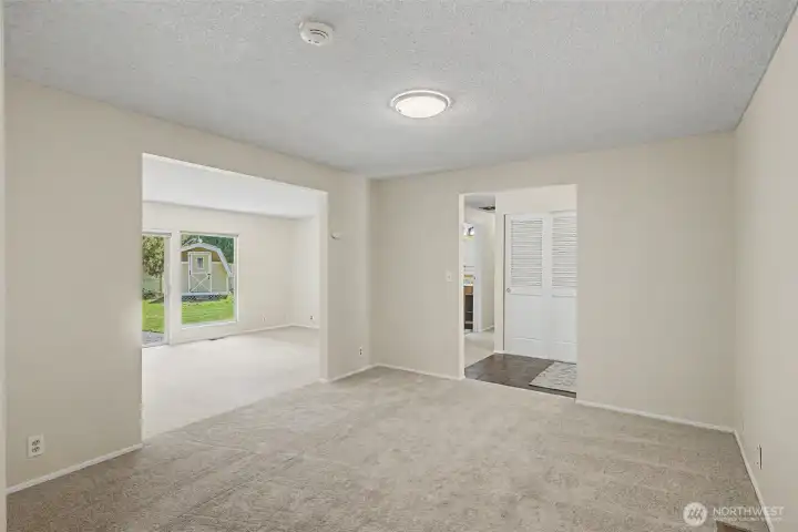 Large dining area with new carpet off of entry