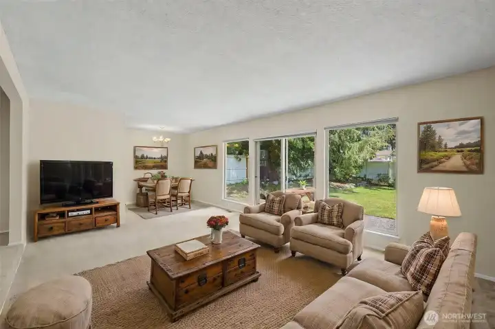 Virtually stage living room showing informal dining in background