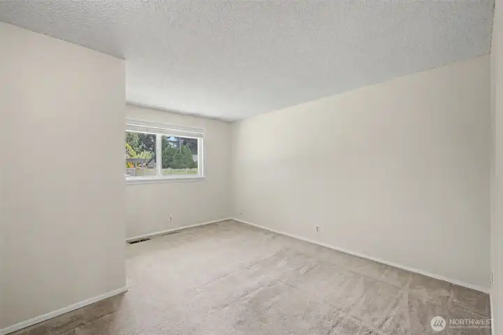 Primary bedroom overlooks backyard