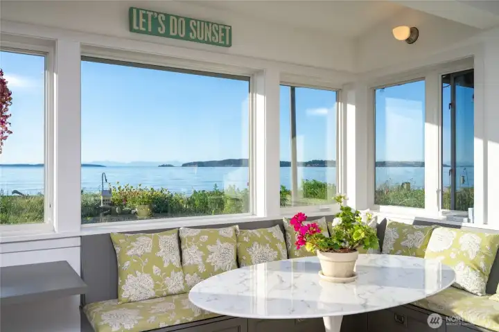 Banquette dining off the kitchen with forever views