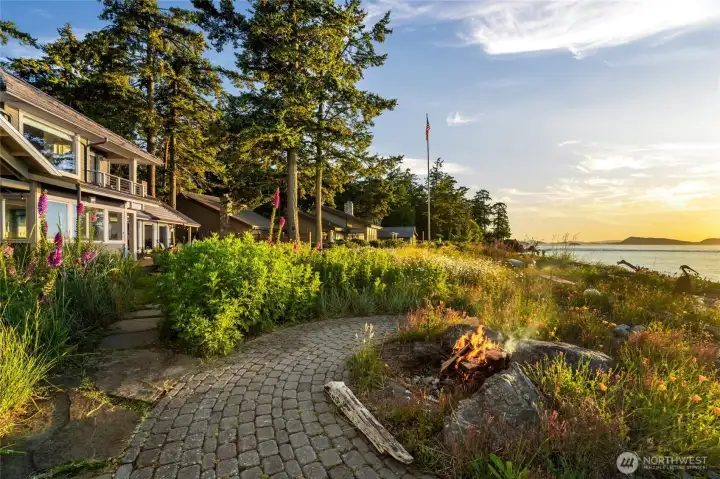 Stone pathway to fire pit, home, beach, sunsets, clouds, and distant islands