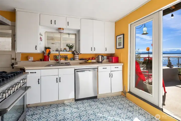 Kitchen feels newer stainless steel appliances, including gas range.