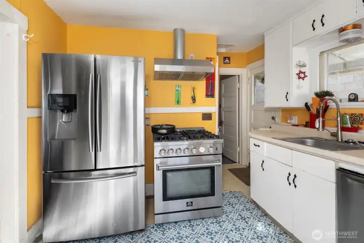 Kitchen feels newer stainless steel appliances, including gas range.