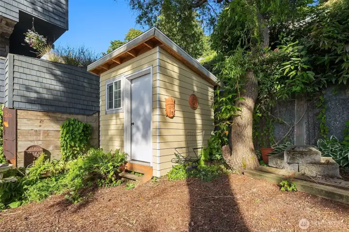 Convenient shed located in front yard.