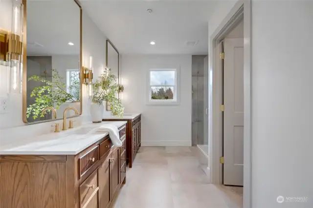 Bathroom has quartz counters and tile flooring and shower