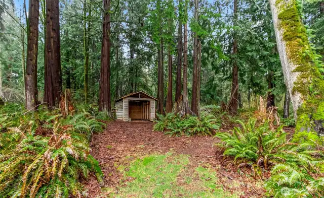 Outdoor storage shed could be used for riding lawnmower.