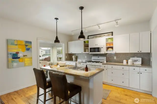 Whip up delicious memories in the kitchen with granite tile counters, crisp white cabinetry, and a breakfast bar.
