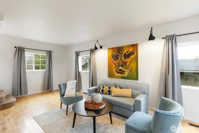 Hardwood floors, stylish lighting, tall ceilings, and lovely millwork.