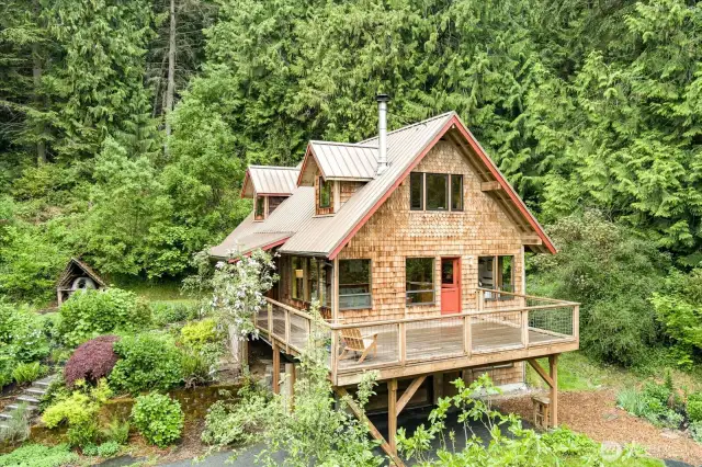 Craftsman cottage in the woods but surrounded by bountiful gardens.