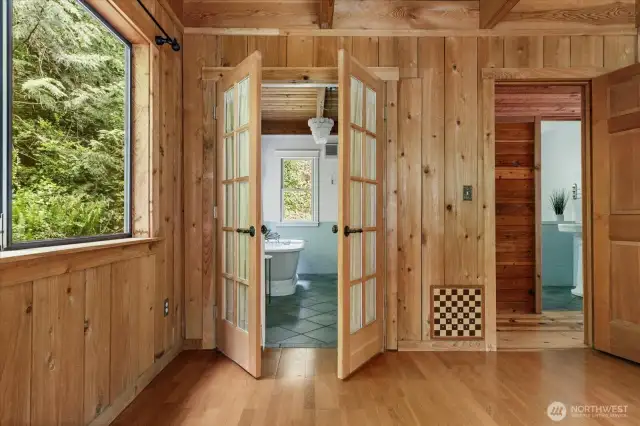 French doors lead through to spacious main floor bathroom.