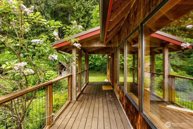 Deck spans length of house on this side.