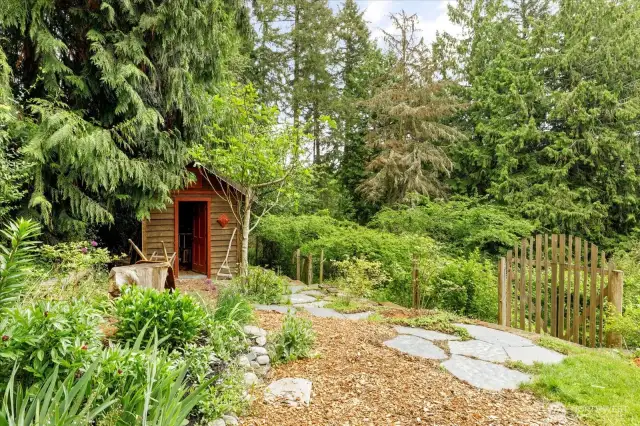 Heading back towards garden you can see a very handy garden shed with lots of storage space on both sides.